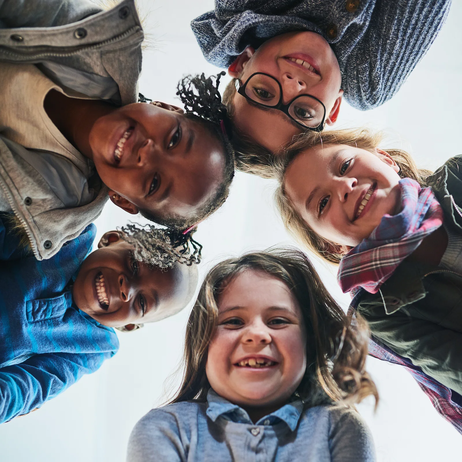 Children smiling together in a circle